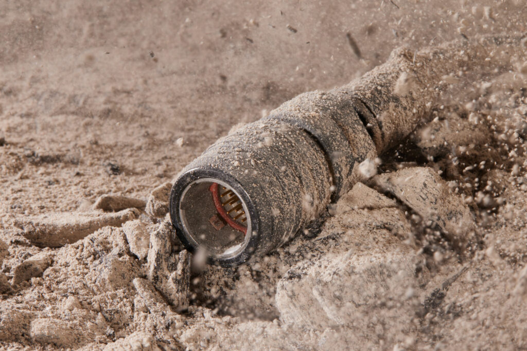 a photo of a CMA connector covered in dust in a harsh environment
